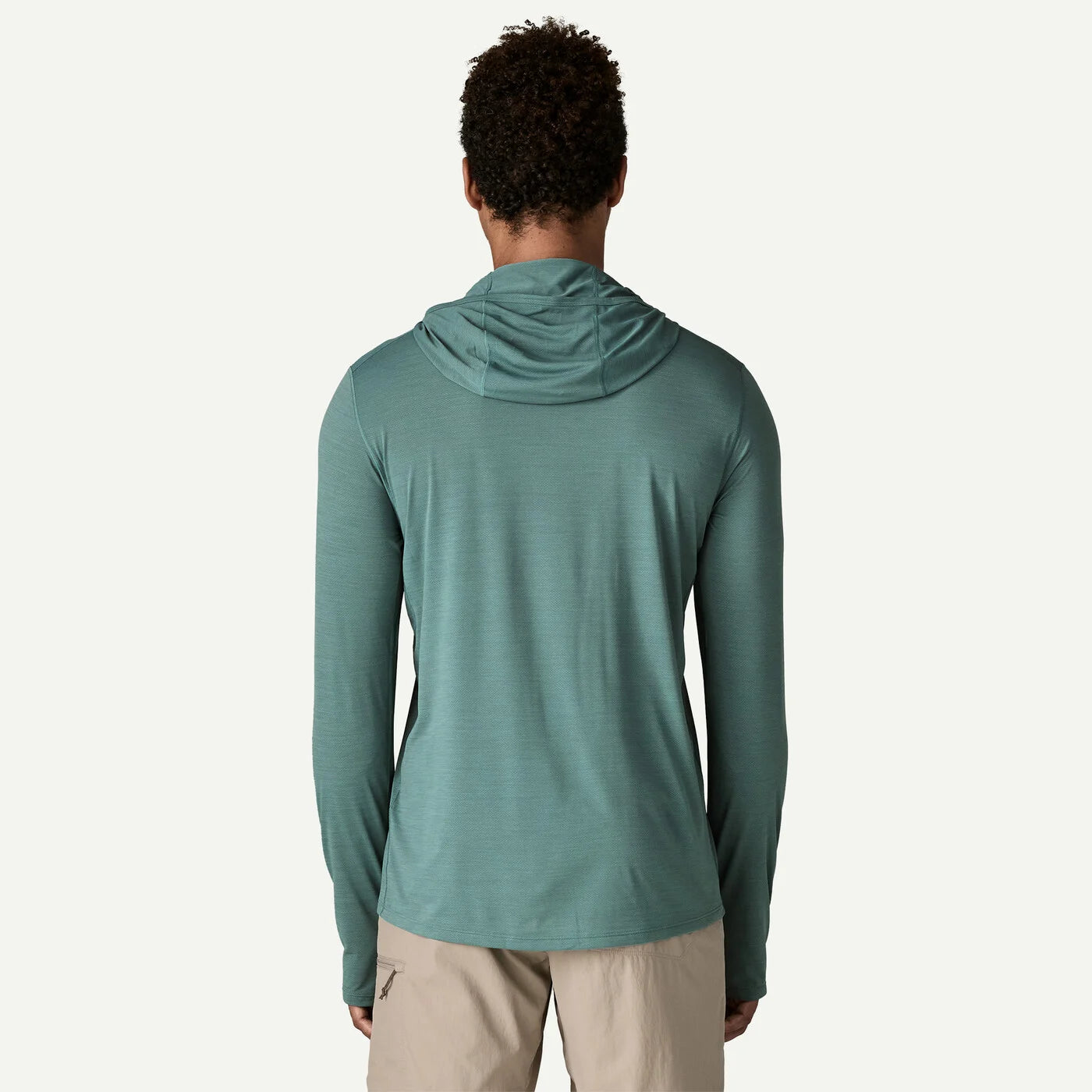 Person wearing a teal hoodie on a white background