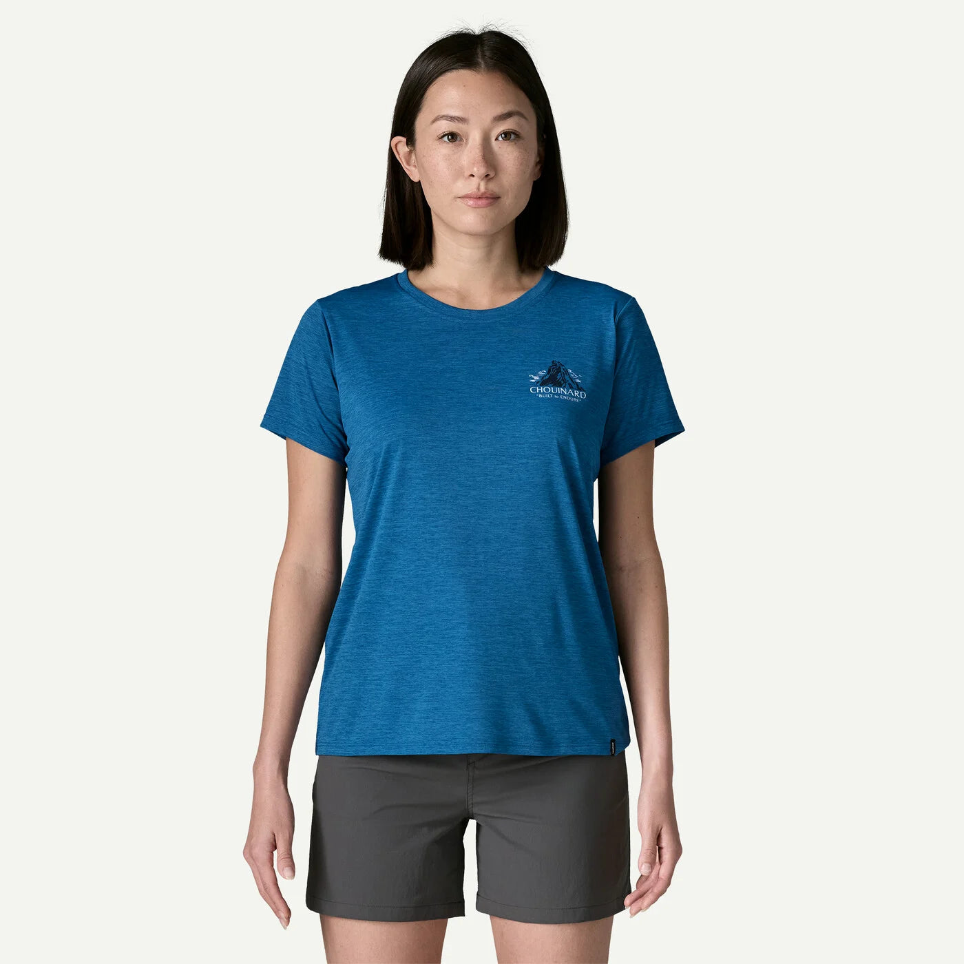 Woman wearing a blue t-shirt with a logo on a white background