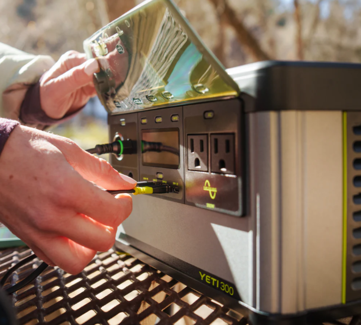 the goal zero yeti 300 6th generation portable battery, shown being used on a picnic table