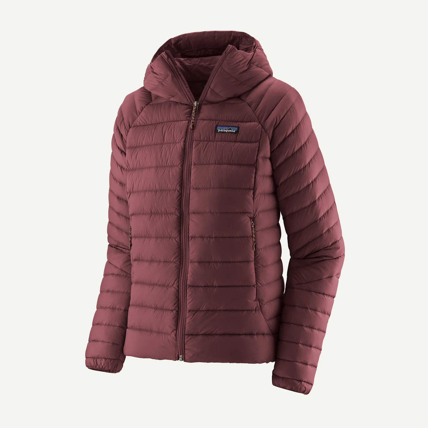 A women's quilted puffer jacket in a dusty burgundy color, featuring a hood, full zip front, and a small blue and white Patagonia logo patch on the left chest, set against a plain off-white background.