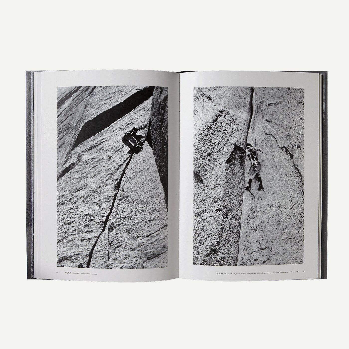 An open hardcover book showing two black-and-white photographic pages of a rock climber on a steep cliff face, photographed against a light gray background.