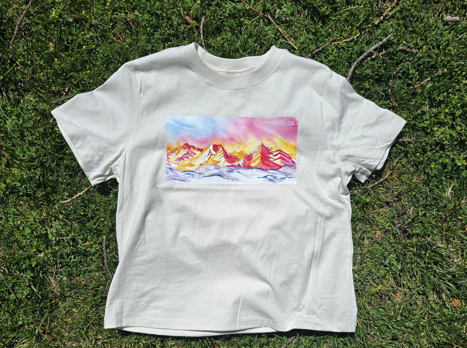 white women's t-shirt with colorful mountain graphic