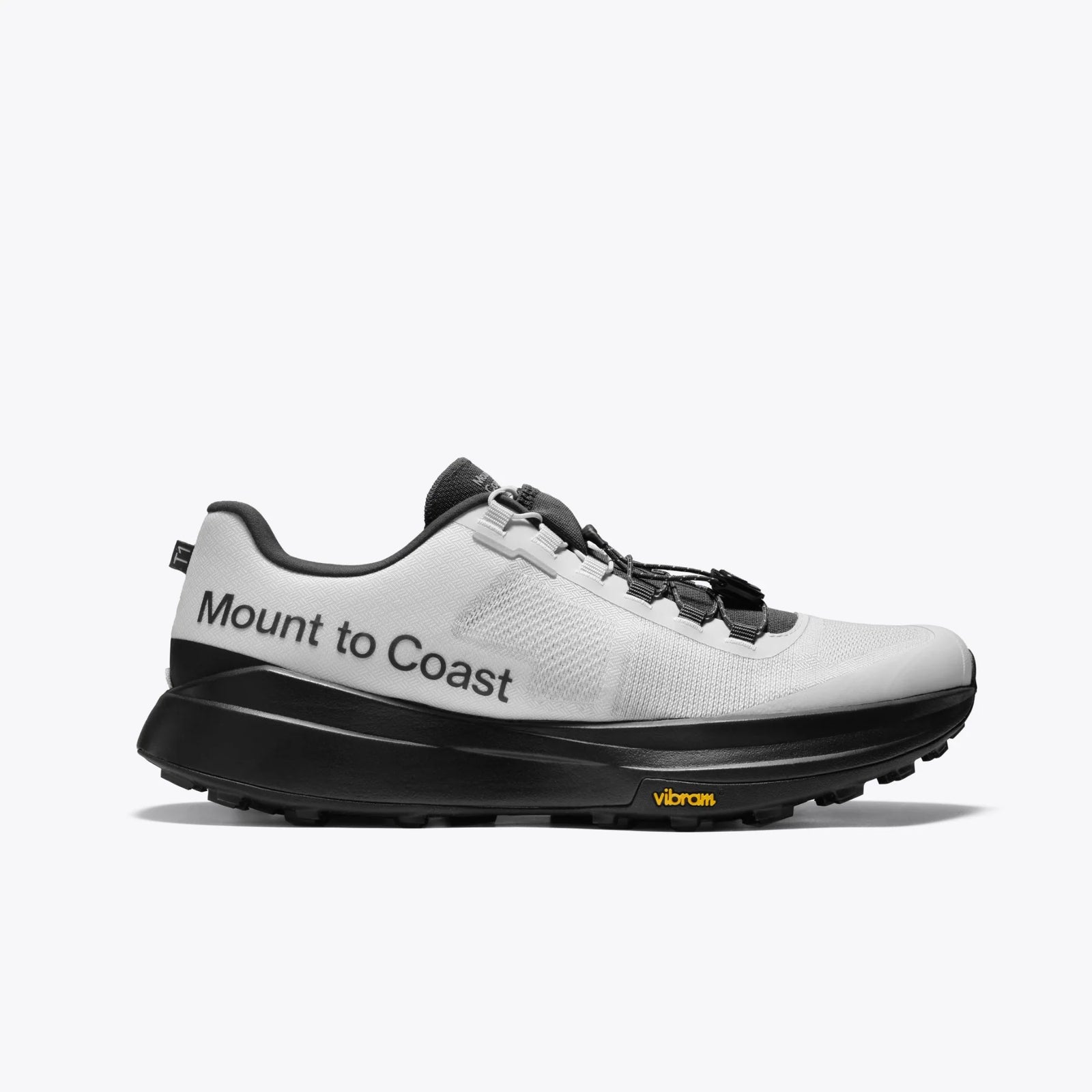White and black running shoe with 'Mount to Coast' branding on a white background