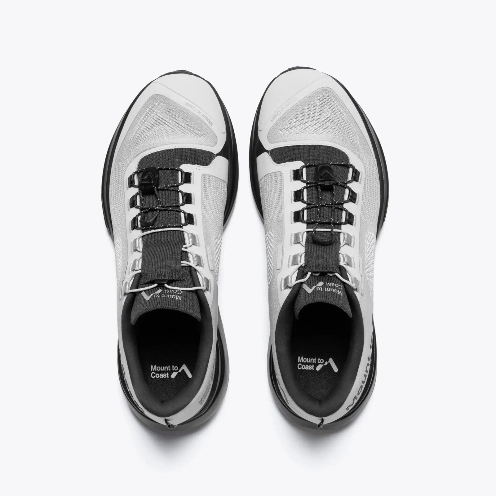 Pair of white and black athletic shoes on a white background