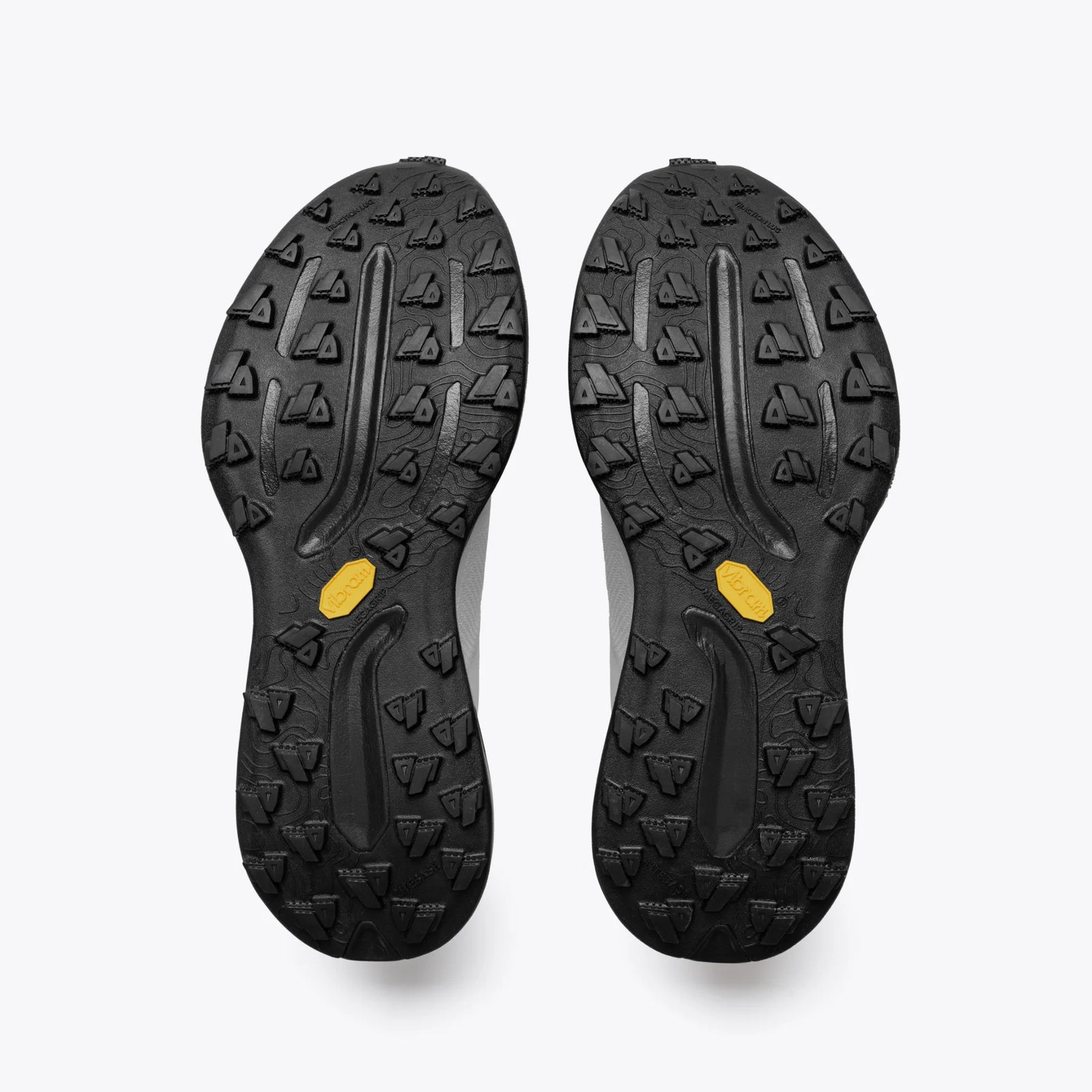 Black shoe soles with a textured pattern on a white background