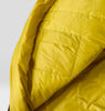 Close-up of a yellow sleeping bag interior showing small pocket on a light gray background
