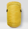 Yellow stuff sack containing sleeping bag on a light gray background