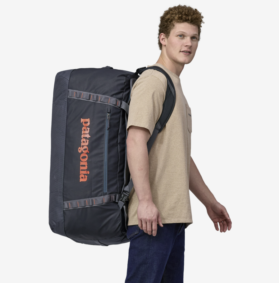 the patagonia black hole duffel in color smolder blue, shown with a model