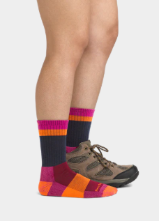 darn tough heady betty sock in clover on a model with one boot on