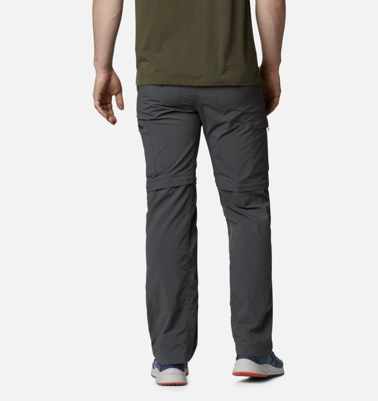 a photo of a model wearing the columbia silver ridge convertible pants in the color grill, back view