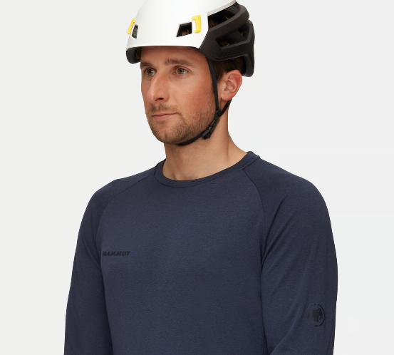 an awkward model wearing the mammut wall rider mips helmet