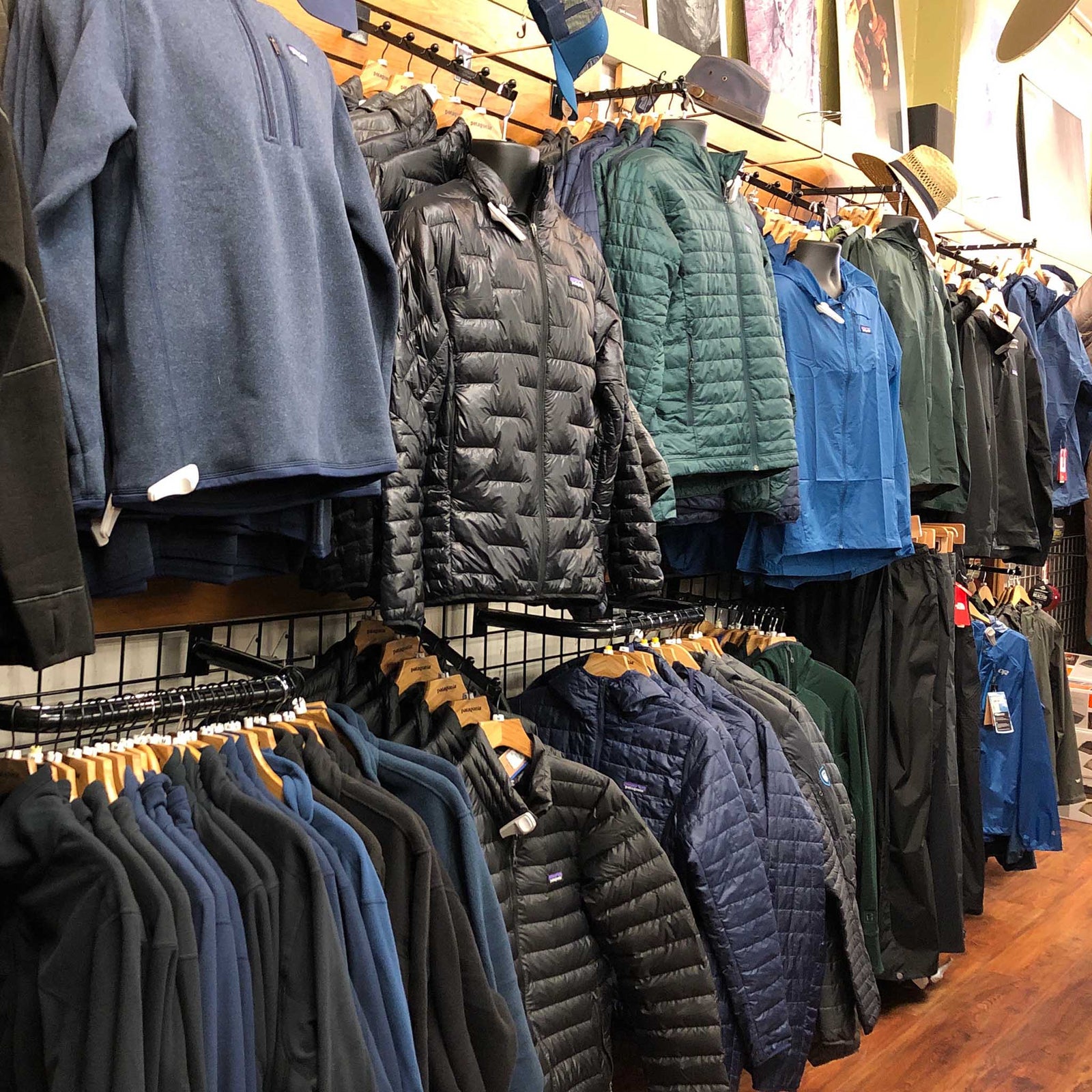 An assortment of men's clothing hangs on a wall