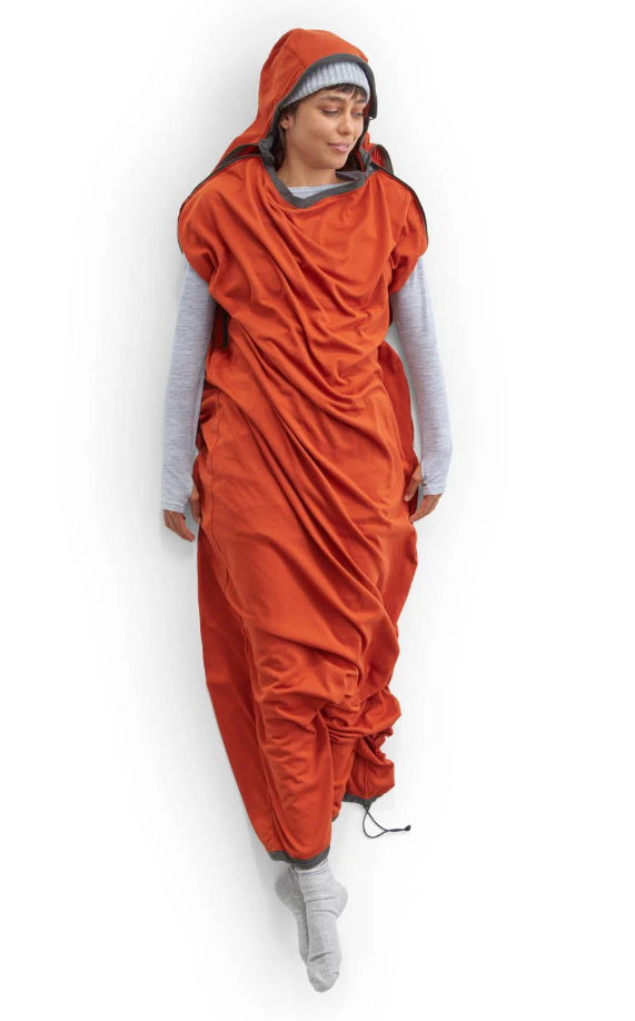 the sea to summit reactor fleece sleeping bag liner shown with a person inside of it, arms and feet sticking out