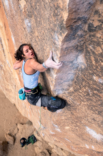 send mini classic knee pad used by a woman while climbing