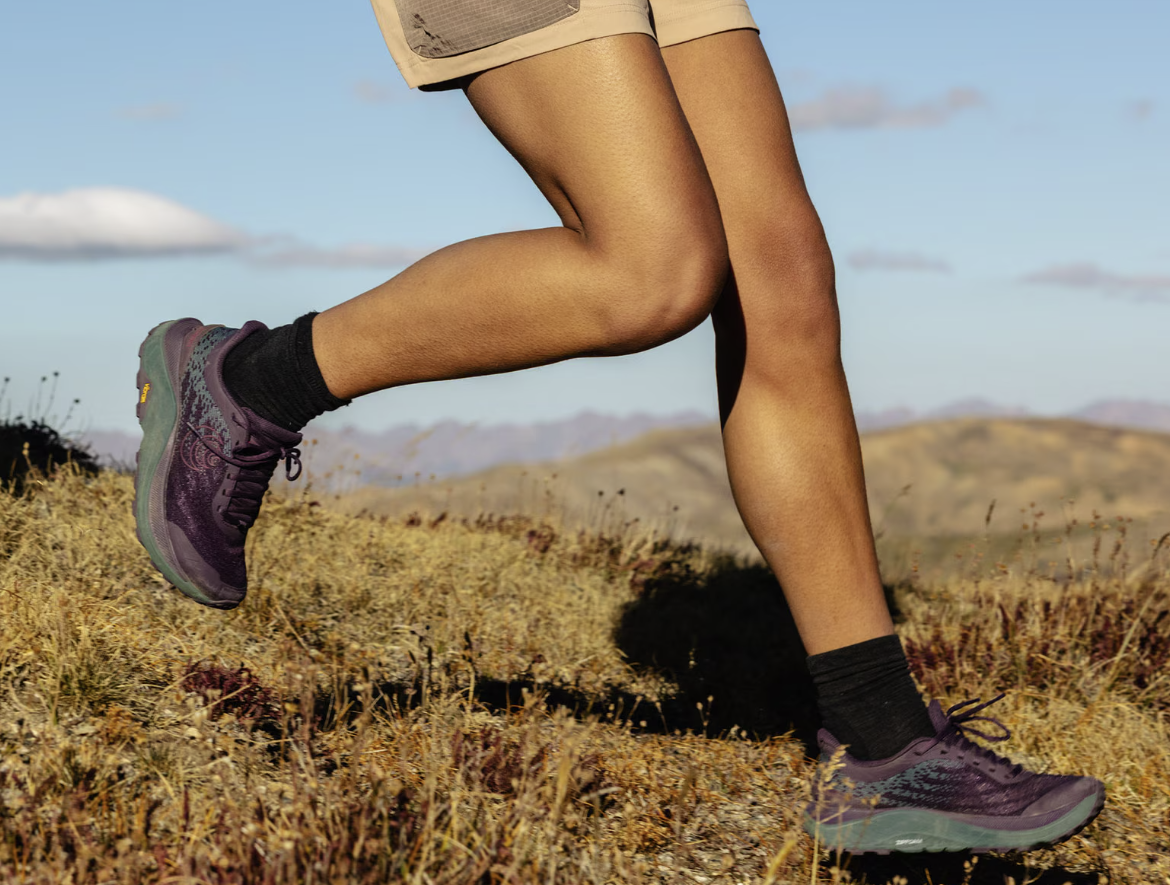 topo ultraventure 4 running shoe womens in color purple, a picture of a model running in them