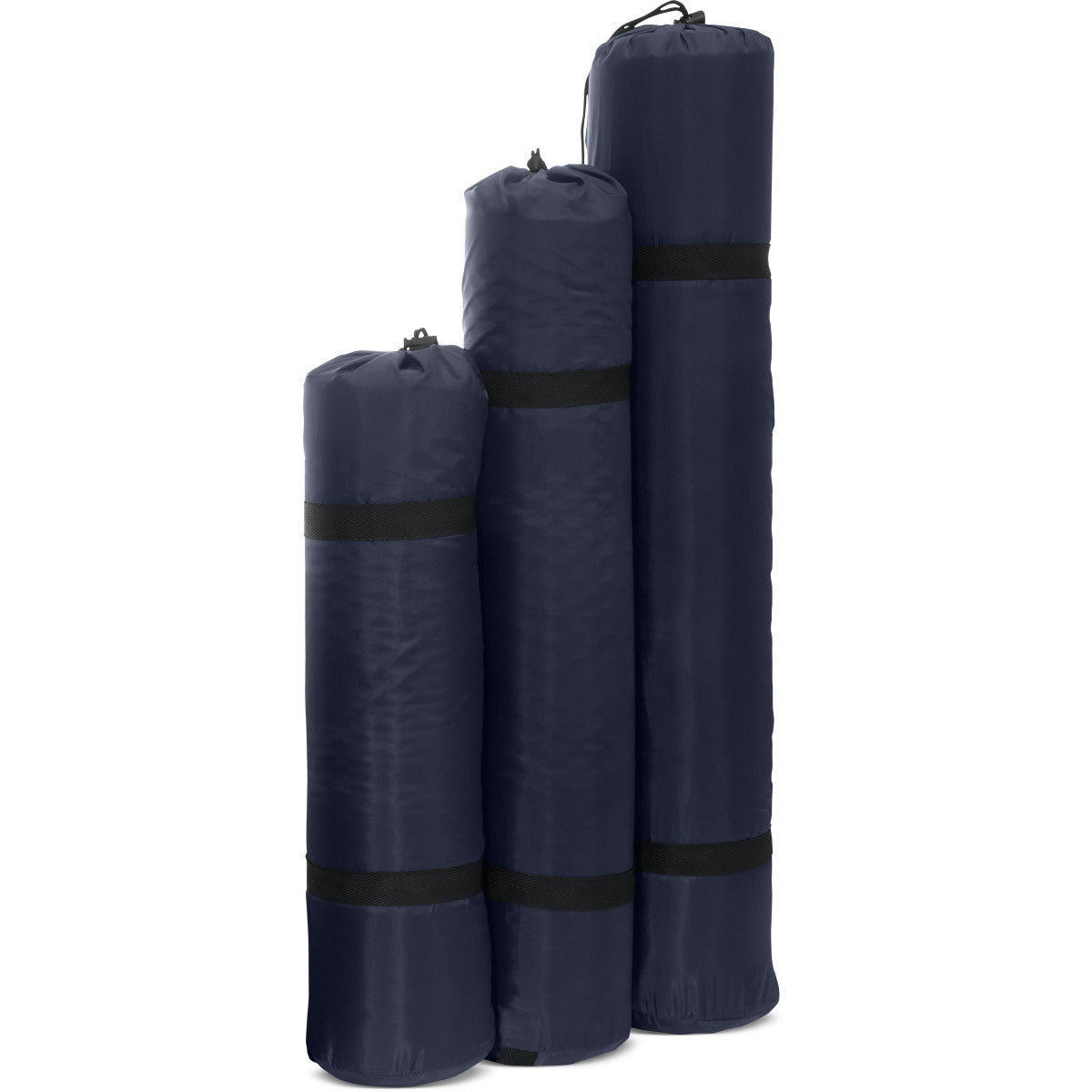 All three sizes of the basecamp sleeping pad rolled up and in stuff bags side by side