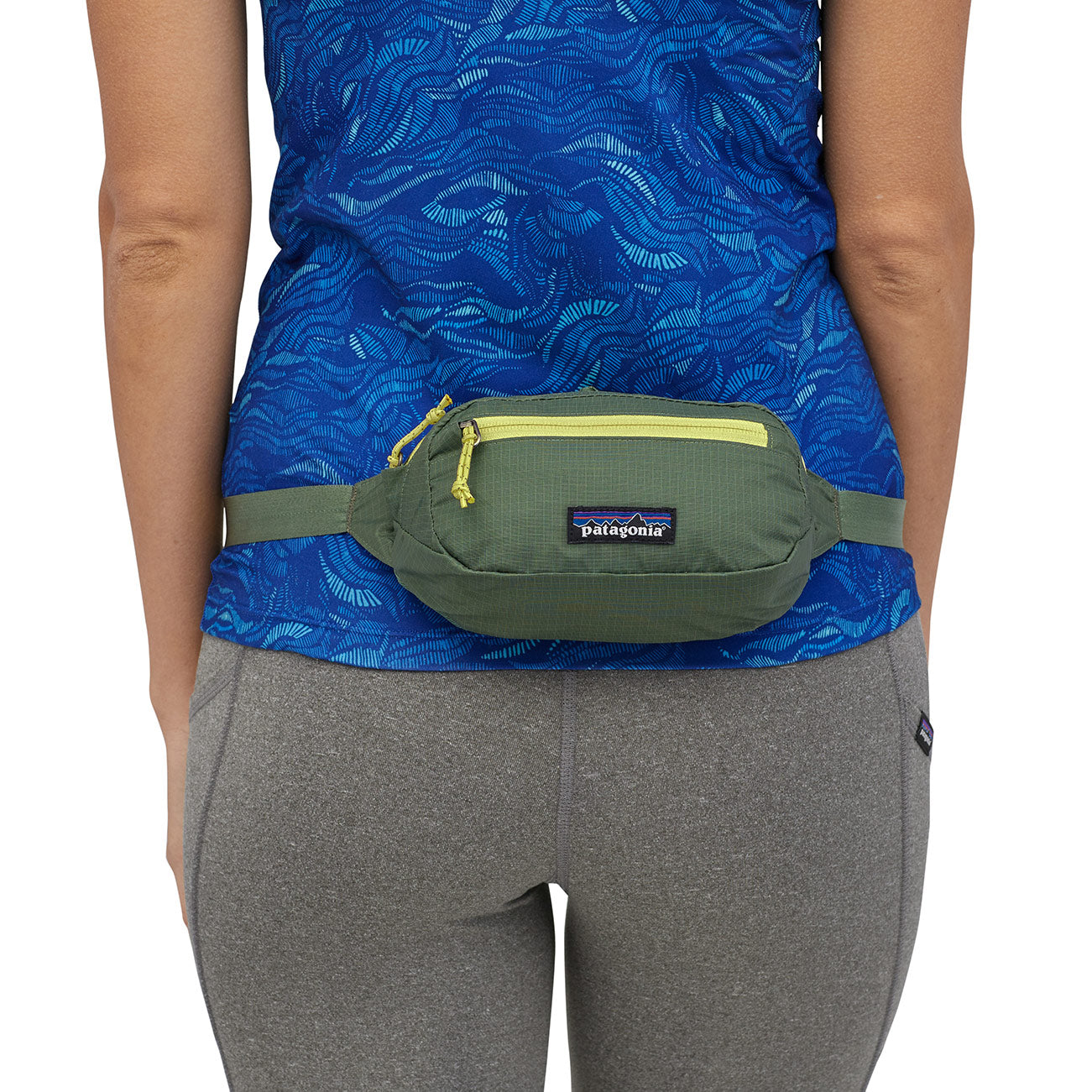 hip pack on live model in green with yellow zippers