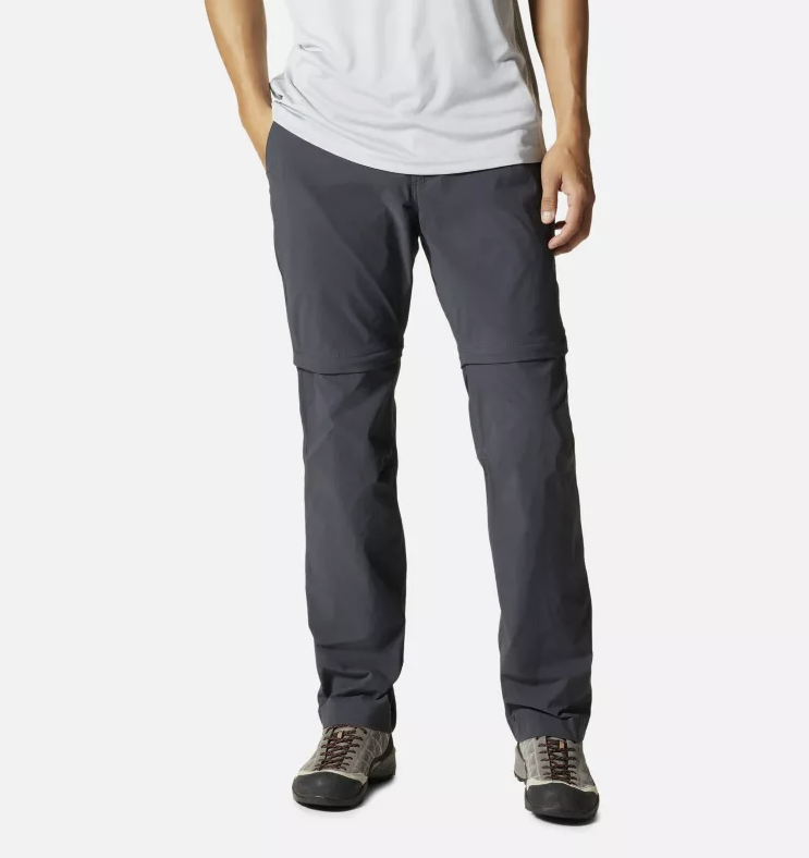 a model wearing the mountain hardwear basin convertible pants men in the color dark storm front view