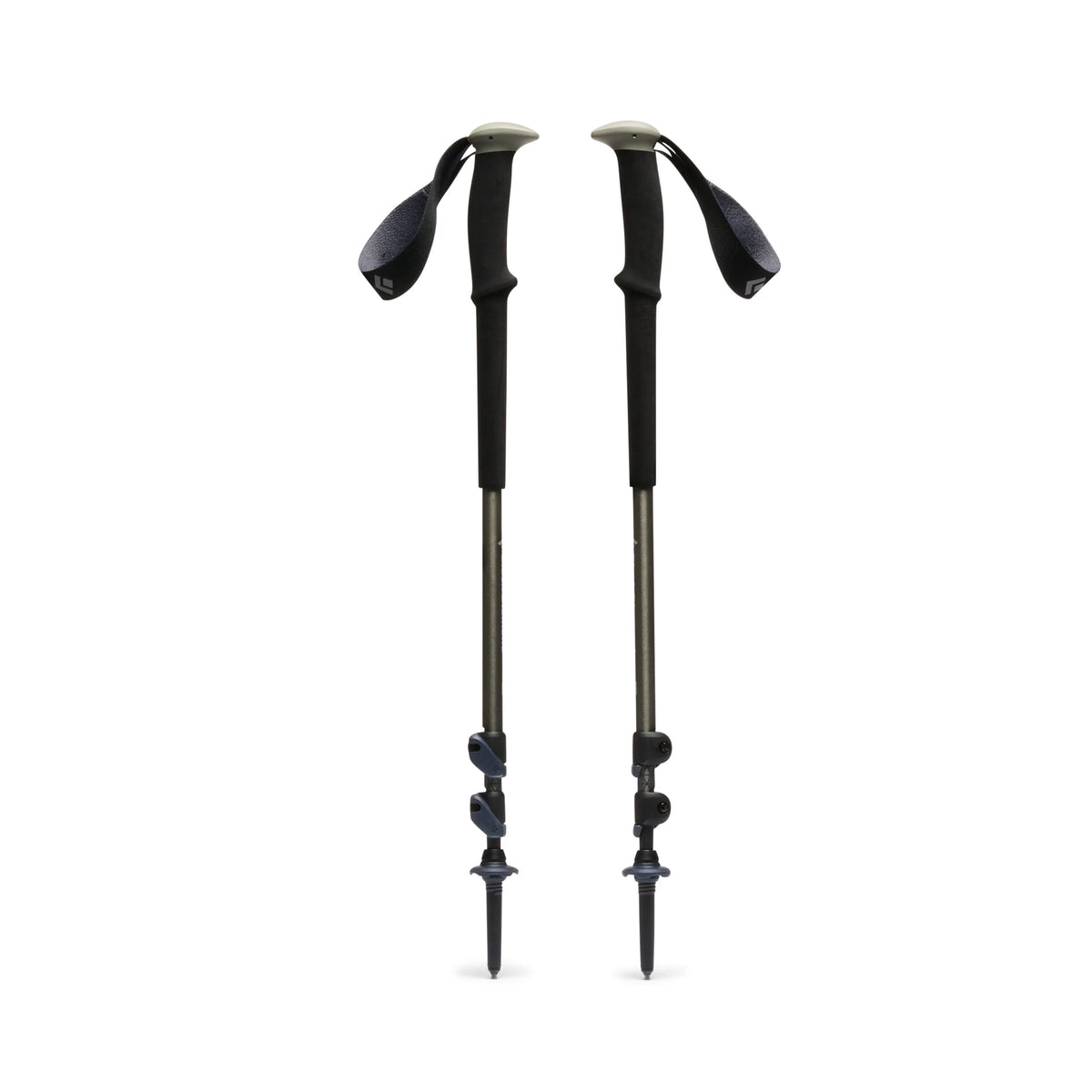 Two green-black hiking poles on a white background