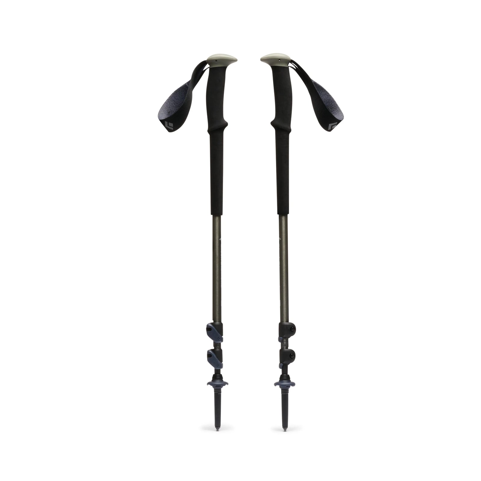 Two green-black hiking poles on a white background