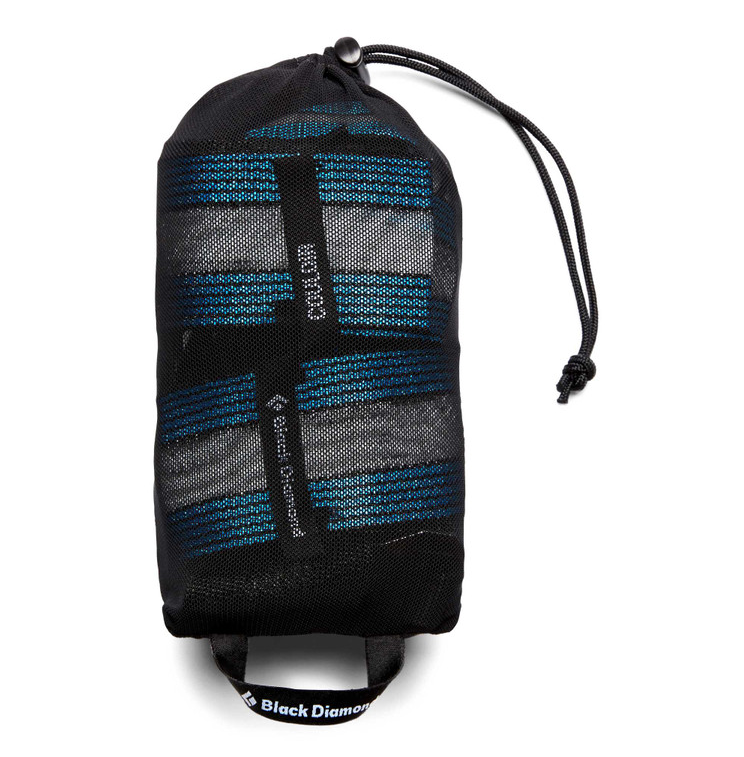 the black diamond coulior harness in the color ultra blue black rolled up in a bag