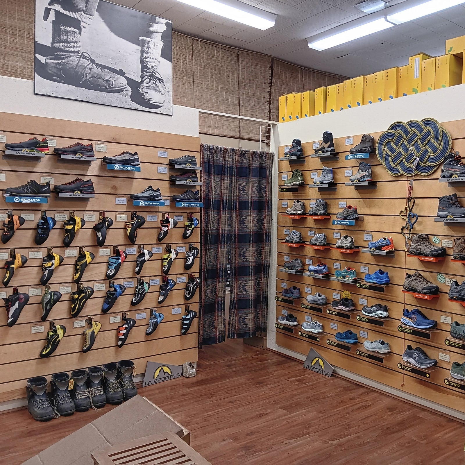 store interior with walls lined with various shoes on shelves.
