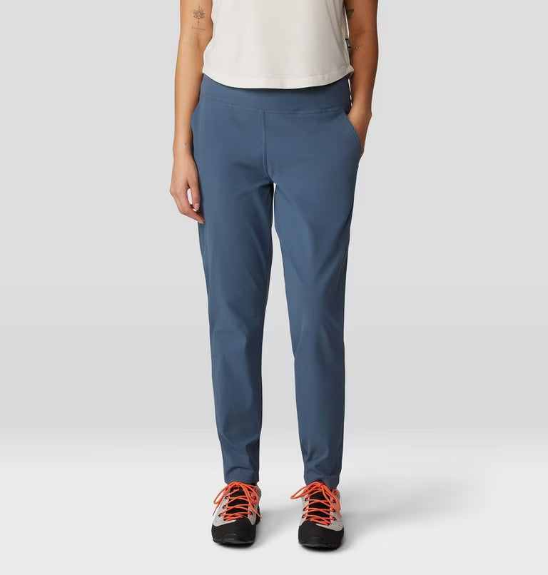 Person wearing blue pants and orange-laced shoes on a white background