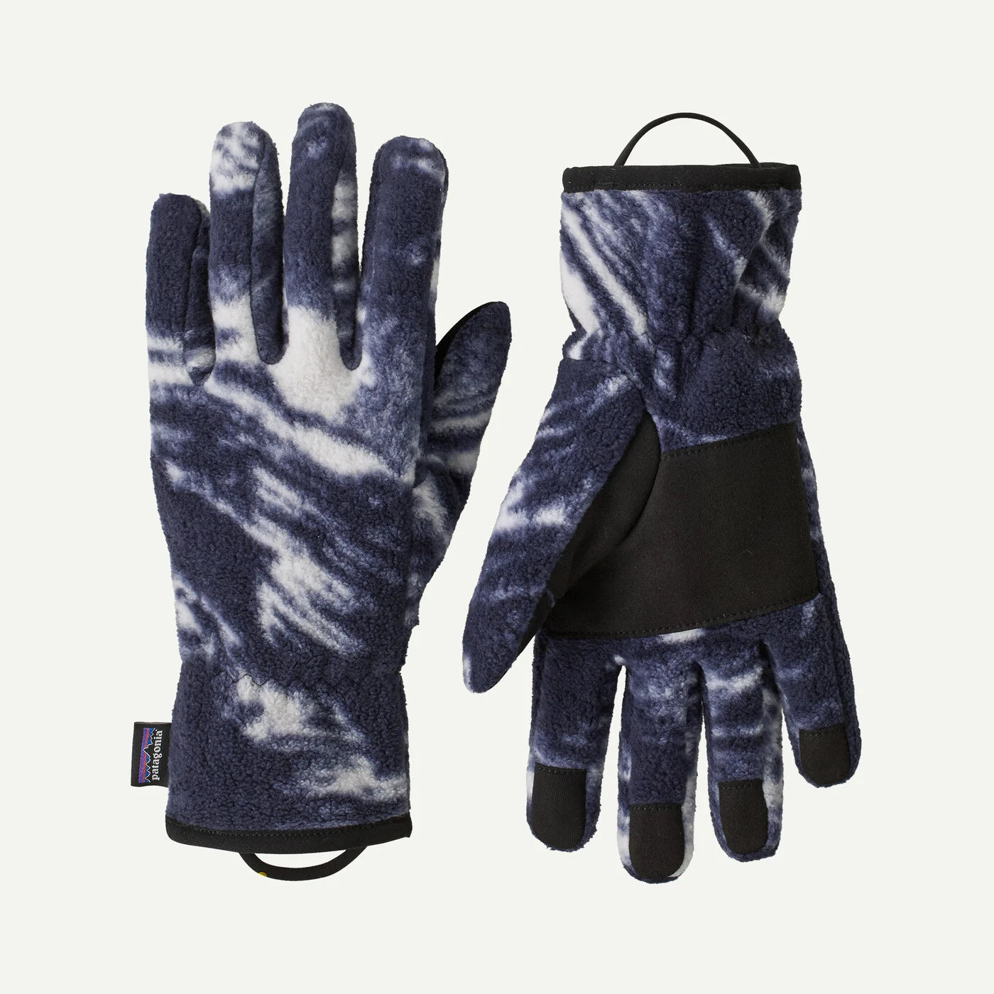 A pair of fleece gloves with a navy blue and white tie-dye pattern, featuring black accents on the palms, backs, and fingertips, shown against a light off-white background.