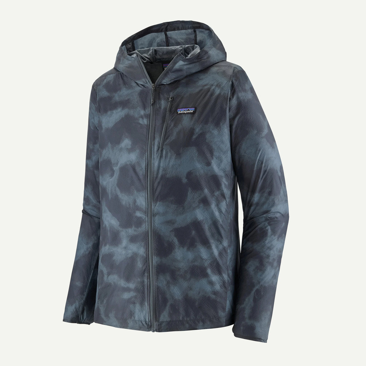 A Patagonia hooded jacket with a dark slate blue and gray tie-dye pattern, featuring a full-zip front and the brand's logo patch on the left chest, set against a plain off-white background.
