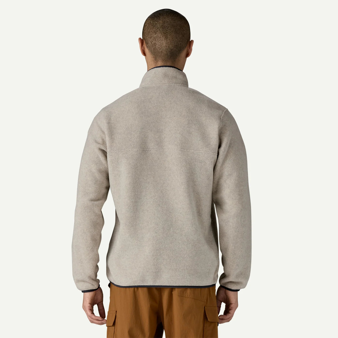 Man wearing a gray fleece jacket on a white background