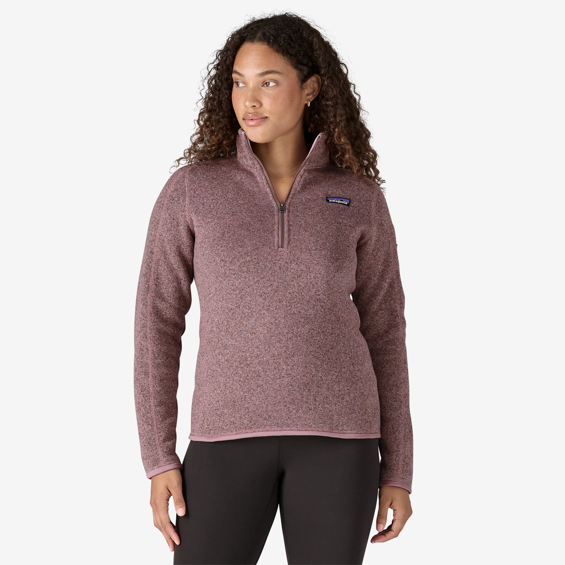 front view of the patagonia womens better sweater quarter zip fleece in the color stormy mauve, on model, front