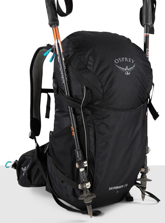 a photo of the osprey skimmer 28 backpack in the color black, detail view of the trekking pole attachment system
