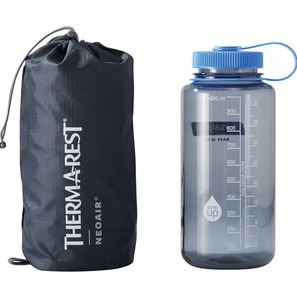 the thermarest neoair xlite nxt sleeping pad, shown rolled up in its stuff sack next to a water bottle