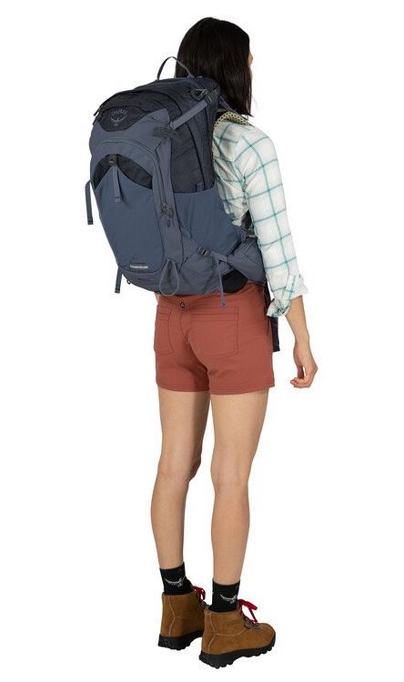 a photo of the osprey mira 32 liter pack in the color anchor blue, view on a model from the back