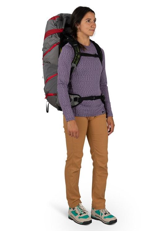 a photo of the osprey eja pro 55 backpack in the color dale grey poinsettia red, front view on a model
