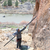 a photo showing someone outside using the metolius roll up stick clip to clip the first bolt of a rock climb