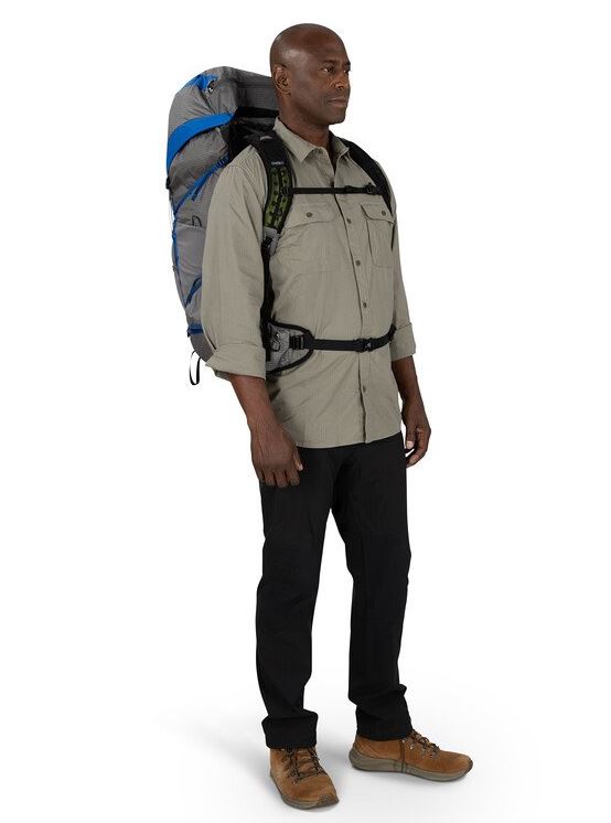 a photo of the osprey exos pro 55 backpack in the color dale grey agam blue, front view on a model
