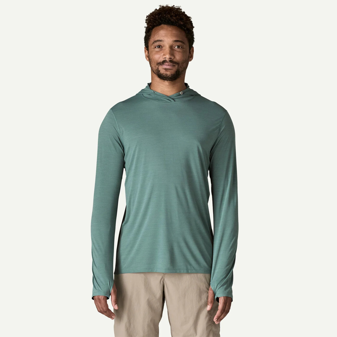 Man wearing a teal long-sleeve shirt on a white background