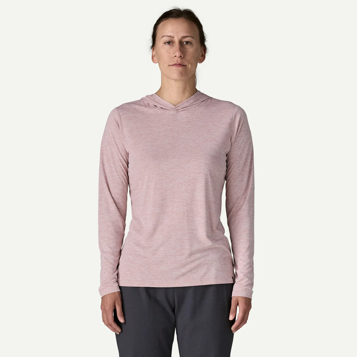 Person wearing a pink long-sleeve hoodie on a white background