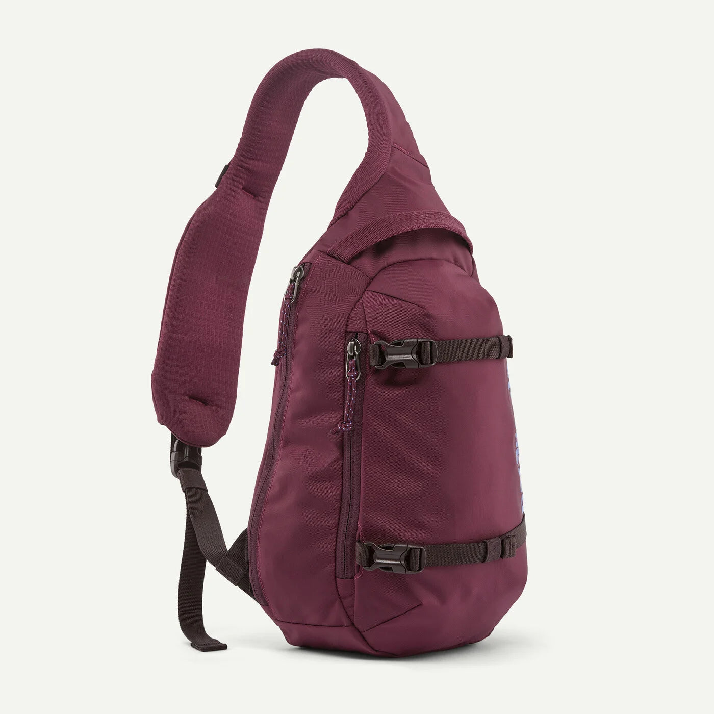 A burgundy sling backpack with black adjustable straps and zippers, shown from a side profile view against a light off-white background.