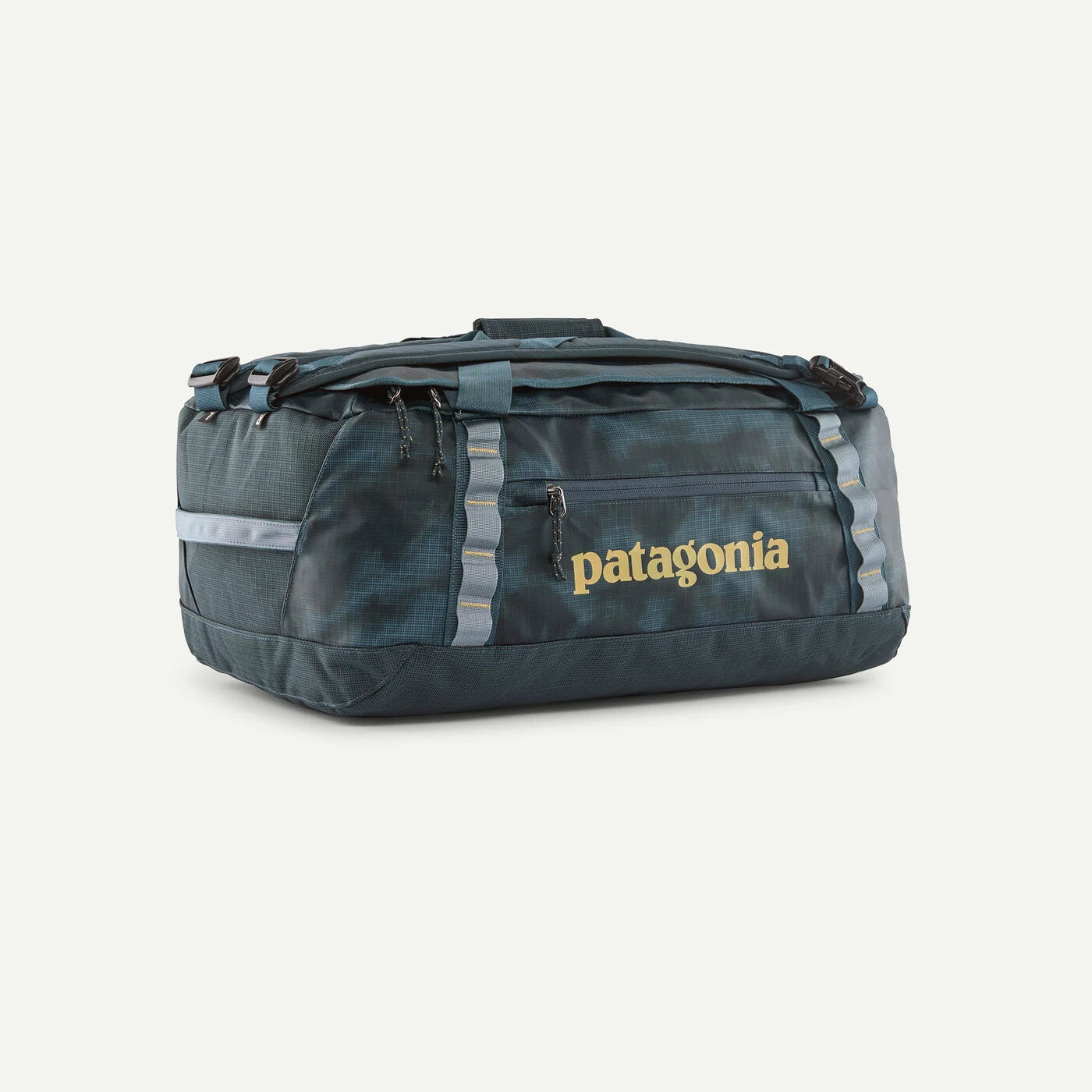 A dark teal marbled Patagonia duffel bag with reflective gray side stripes and a gold Patagonia logo on the front, set against a plain off-white background.