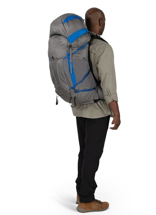 a photo of the osprey exos pro 55 backpack in the color dale grey agam blue, back view on a model