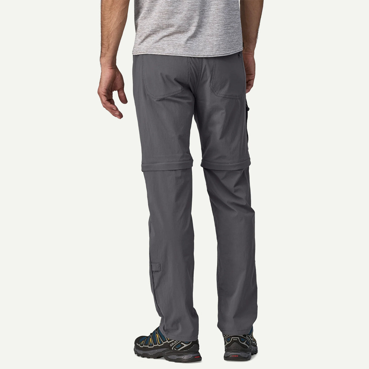 Person wearing gray hiking pants on a white background