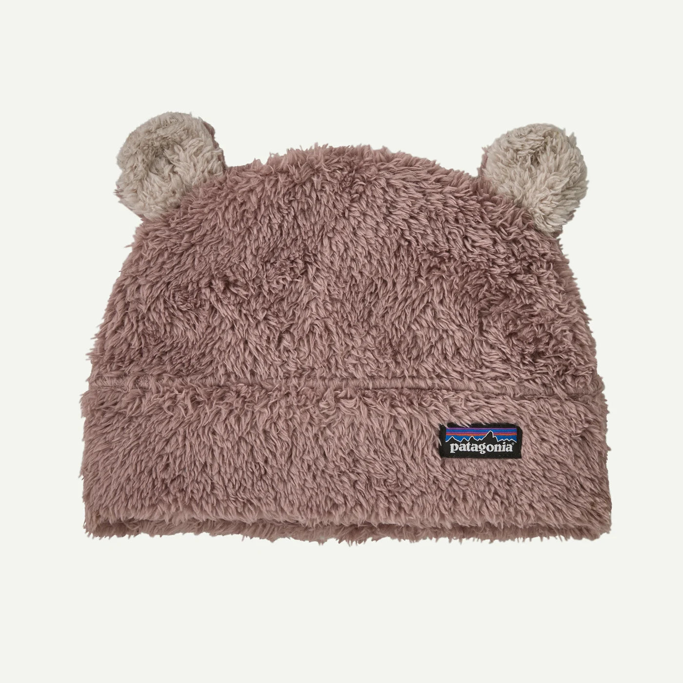 A dusty mauve-brown fuzzy beanie hat with two small bear ears on top and a small Patagonia logo patch on the front, shown against a plain off-white background.