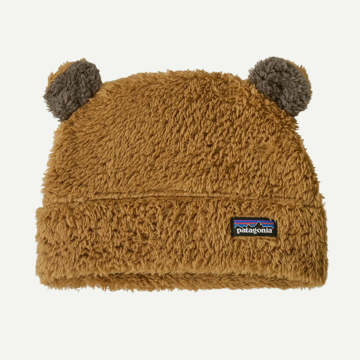 Brown fuzzy beanie with earflaps and Patagonia logo on a white background