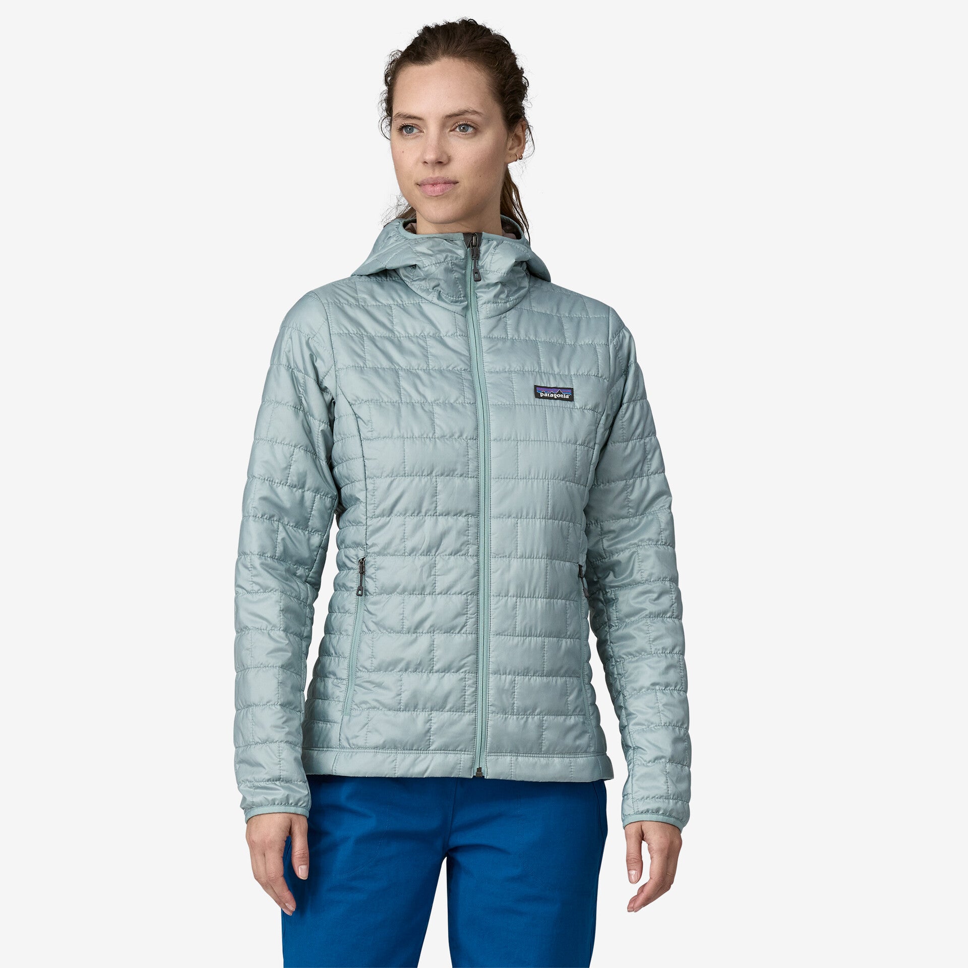 patagonia womens nano puff hoody in the color thermal blue, worn by a model