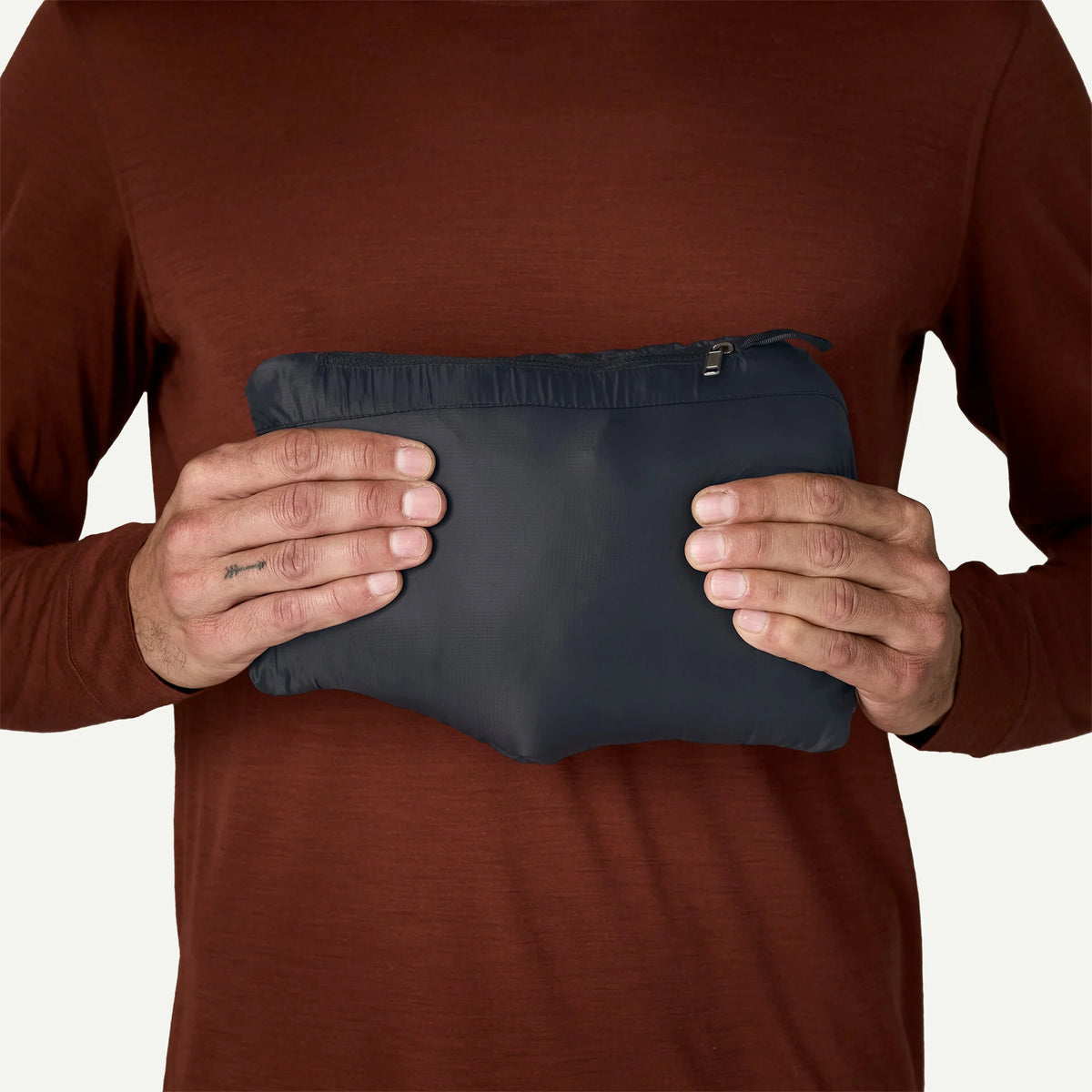 patagonia mens down sweater hoody in black, packaged into its own pocket