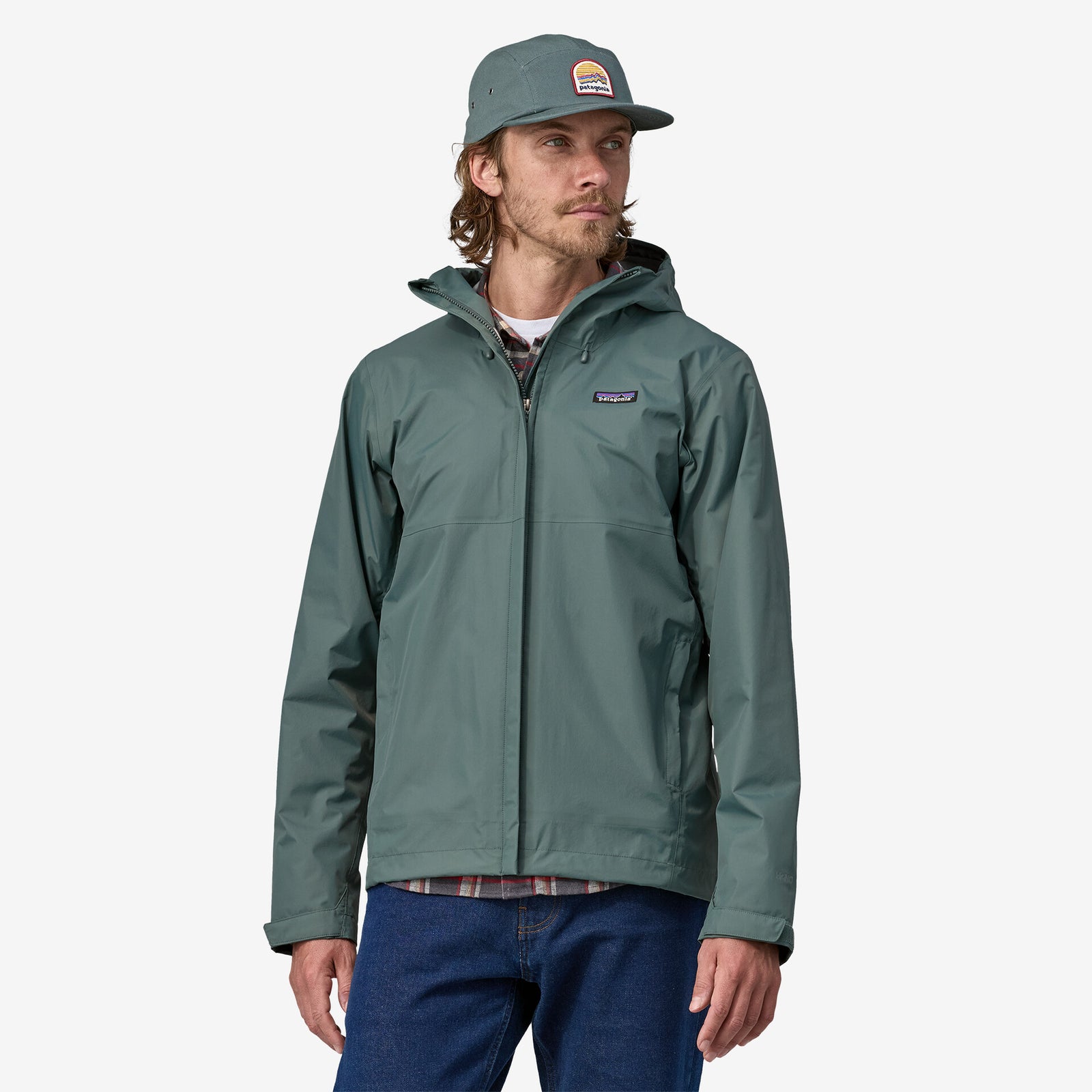 Model wearing Patagonia Torrentshell Jacket in nouveau green, front