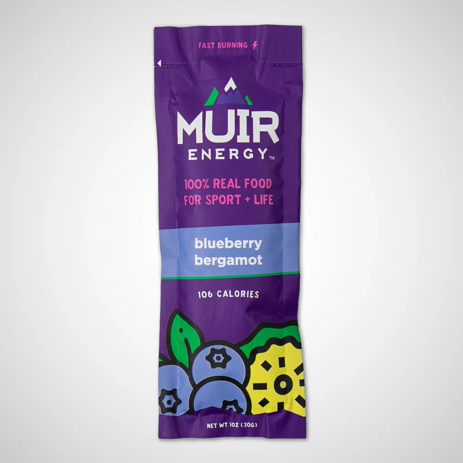 A single Muir Energy snack stick in a purple pouch labeled blueberry bergamot, shown upright on a light gray background.