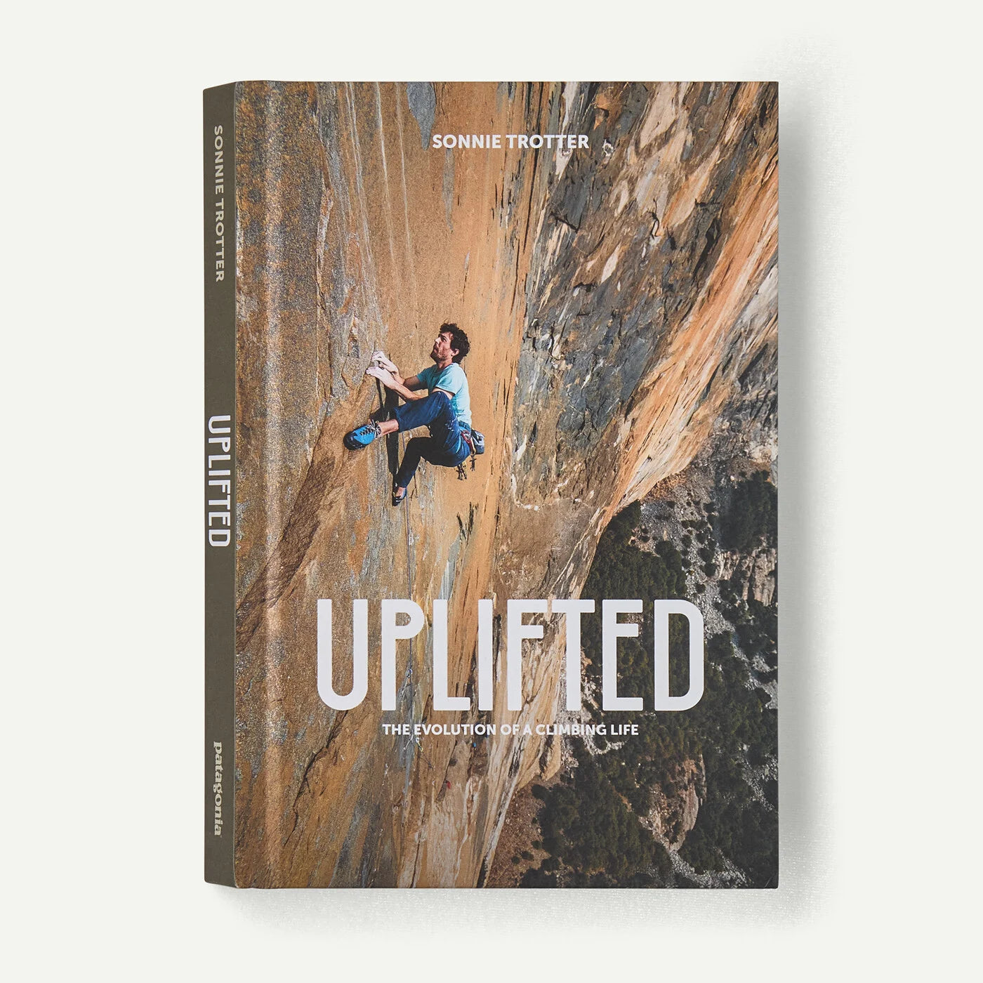 Book titled 'Uplifted' with a climber on a rock face, featuring the author's name.